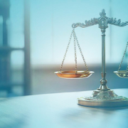 A golden balance scale on a table, with blue color gradients in the foreground and background; the image serves as the key visual for the B&B Bulletin