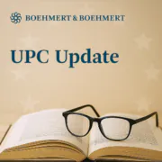 Aufgeklapptes Buch mit Brille vor hellem Hintergrund mit der Headline UPC Update und dem Logo von BOEHMERT & BOEHMERT